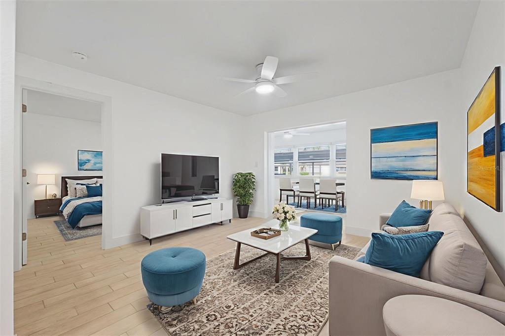 4812 Jasper Drive, Unit 105 New Port Richey, FL 34652 - Photo 11 of 63 a living room with furniture a rug and a flat screen tv