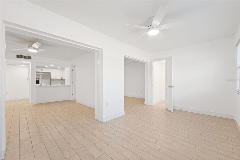 4812 Jasper Drive, Unit 105 New Port Richey, FL 34652 - Photo 13 of 63 a view of a big room with wooden floor and a kitchen
