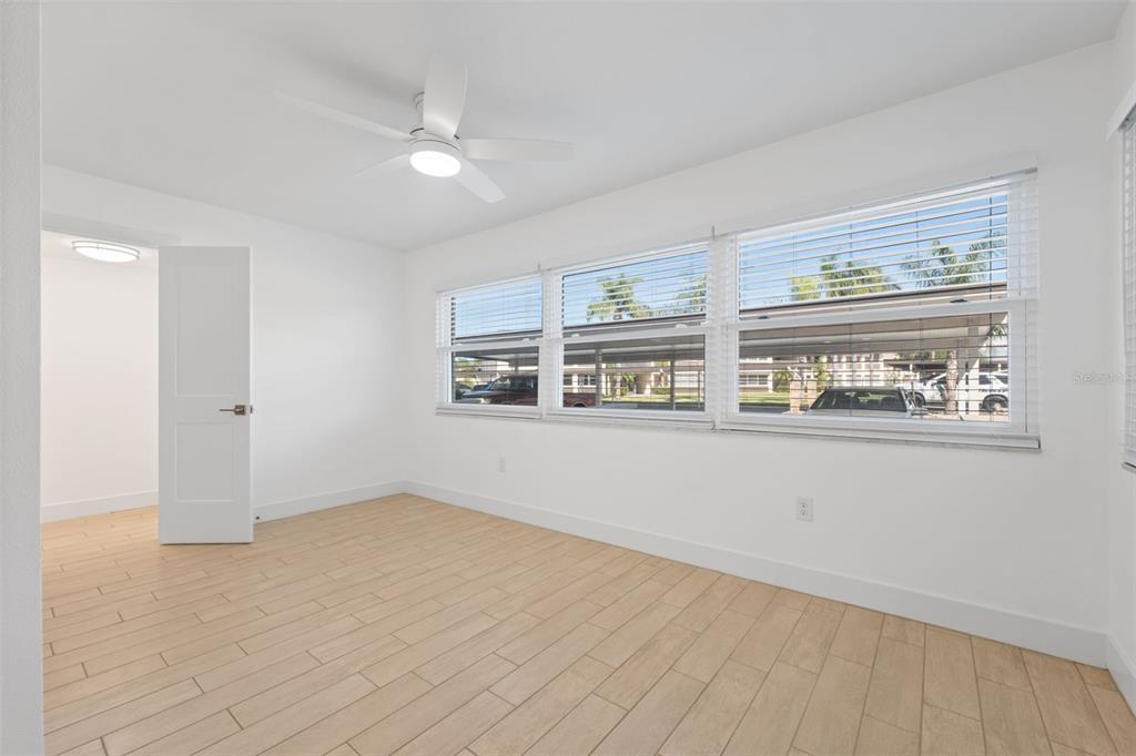 4812 Jasper Drive, Unit 105 New Port Richey, FL 34652 - Photo 15 of 63 a view of an empty room with wooden floor and a window