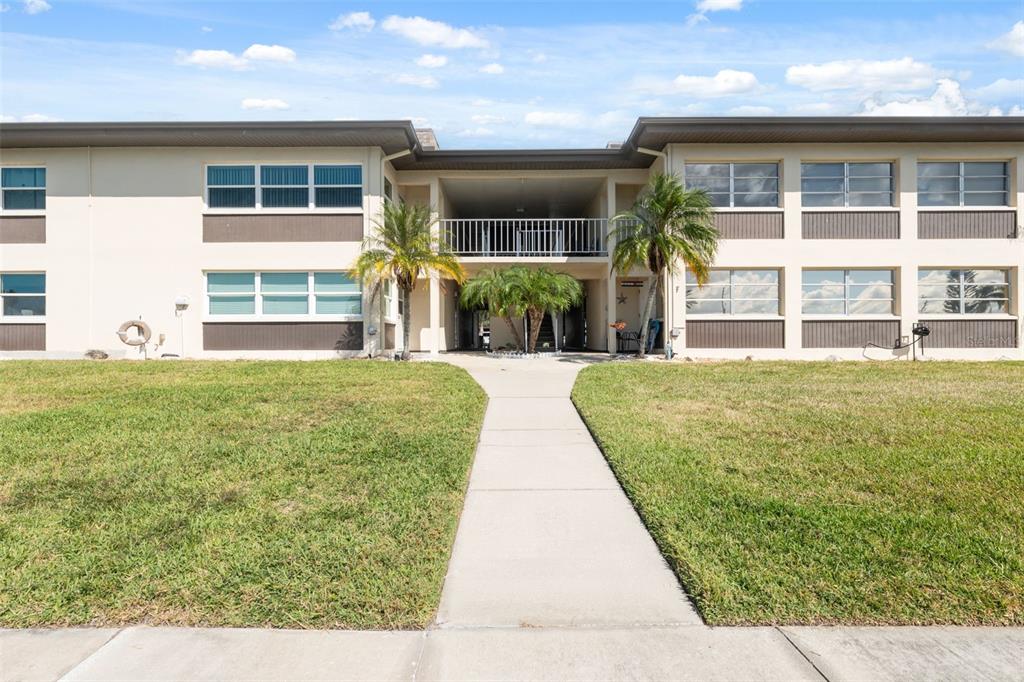 4812 Jasper Drive, Unit 105 New Port Richey, FL 34652 - Photo 2 of 63 a front view of a house with a yard