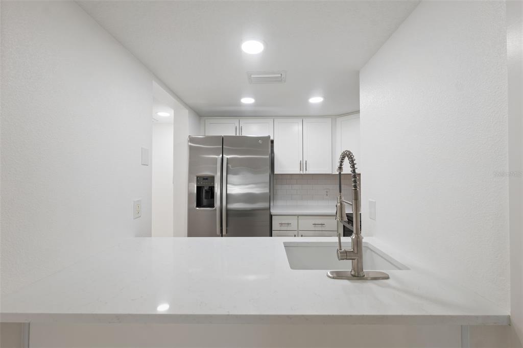 4812 Jasper Drive, Unit 105 New Port Richey, FL 34652 - Photo 24 of 63 a kitchen with stainless steel appliances with a refrigerator
