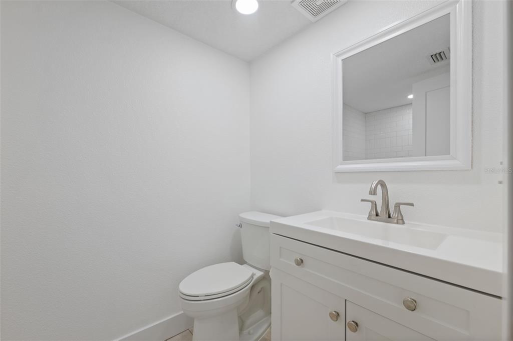 4812 Jasper Drive, Unit 105 New Port Richey, FL 34652 - Photo 28 of 63 a bathroom with a sink a toilet and a mirror