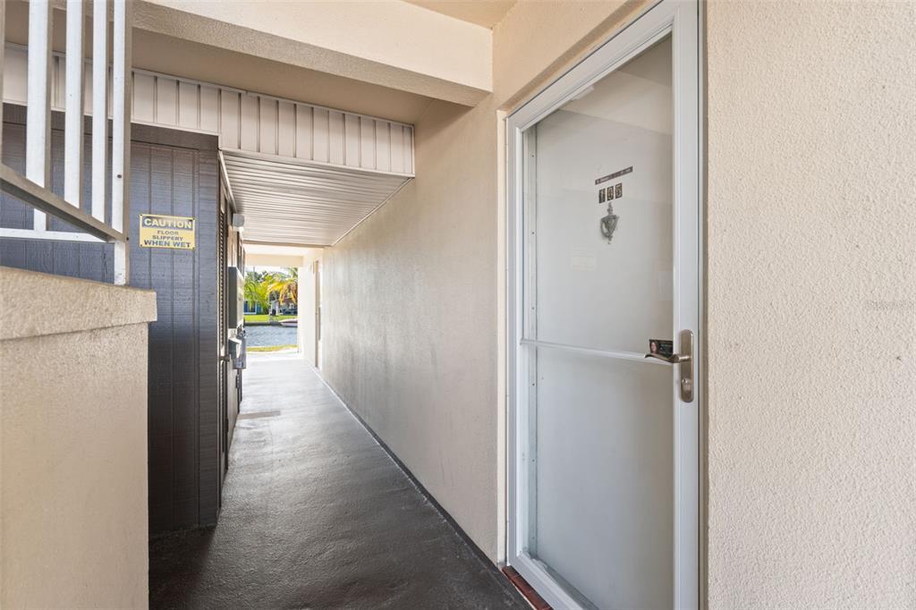 4812 Jasper Drive, Unit 105 New Port Richey, FL 34652 - Photo 8 of 63 a view of a hallway with wooden floor