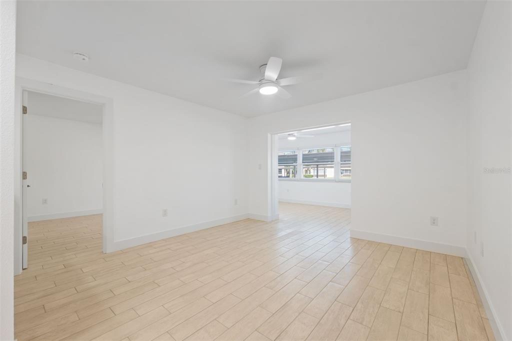 4812 Jasper Drive, Unit 105 New Port Richey, FL 34652 - Photo 10 of 63 wooden floor in an empty room with a window