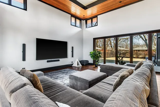 a bedroom with a bed and paintings on wall