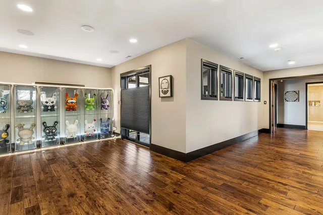 a view of entryway and hall with wooden floor