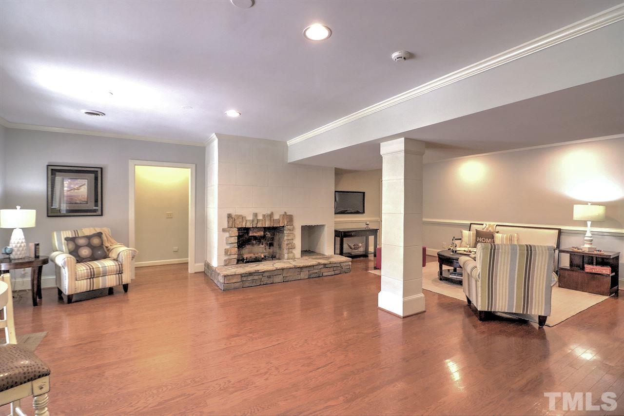 7133 North Ridge Drive Raleigh, NC 27615 - Photo 22 of 30 a living room with furniture and a flat screen tv
