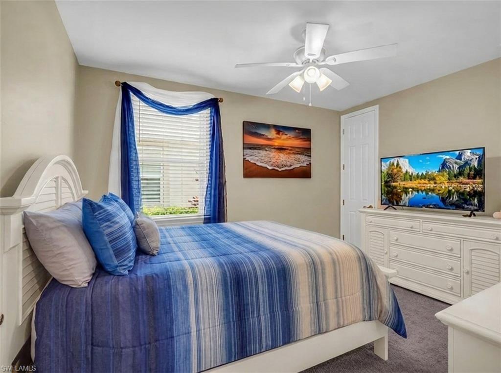 14695 Edgewater Circle Naples, FL 34114 - Photo 19 of 39 a bedroom with a bed and a flat screen tv