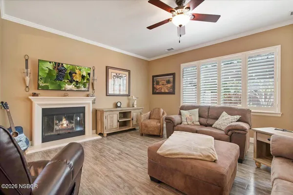 a living room with furniture a fireplace and a flat screen tv