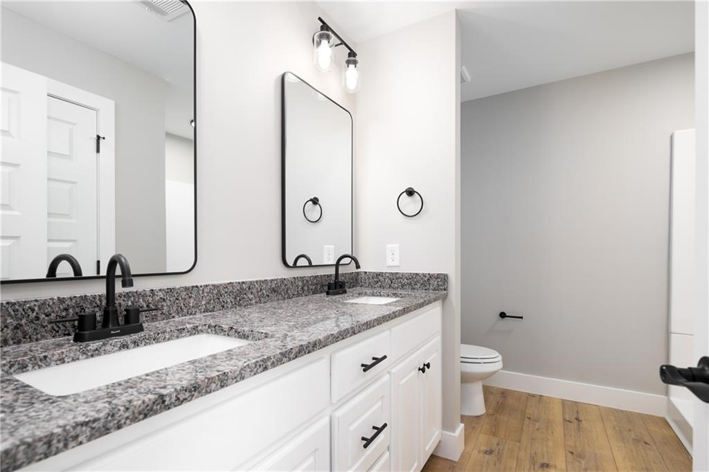 111 Lee Road Phenix City, AL 36867 - Photo 16 of 23 Dual vanity with undermount sinks, granite-style countertop, and matte black fixtures