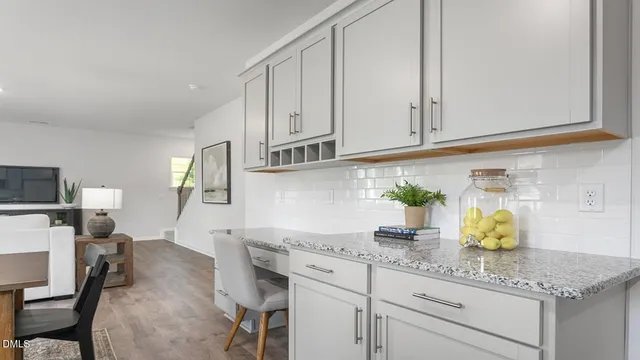 a kitchen with lots of counter top space appliances and dining table