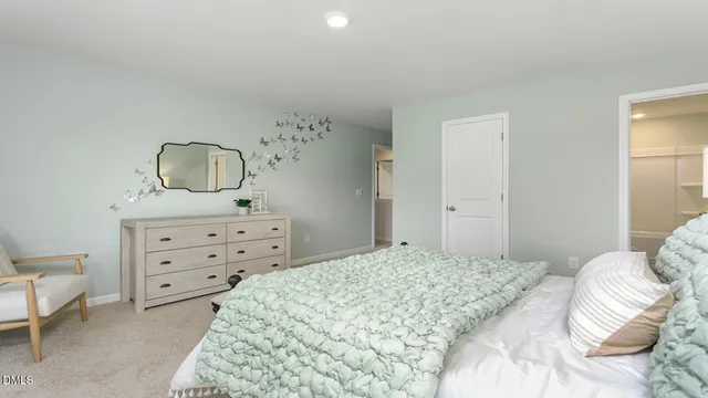 a bed room with a bed and a chair