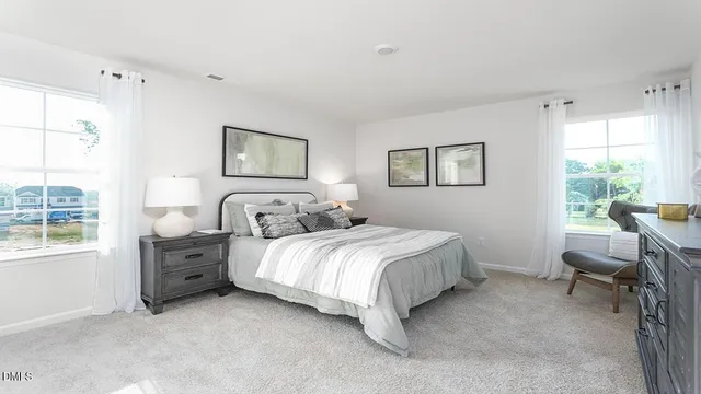 a bedroom with a large bed and a lamp on table