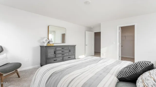 a spacious bedroom with a bed and a window