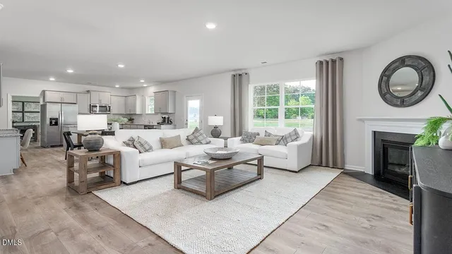 a living room with furniture a window and a fireplace