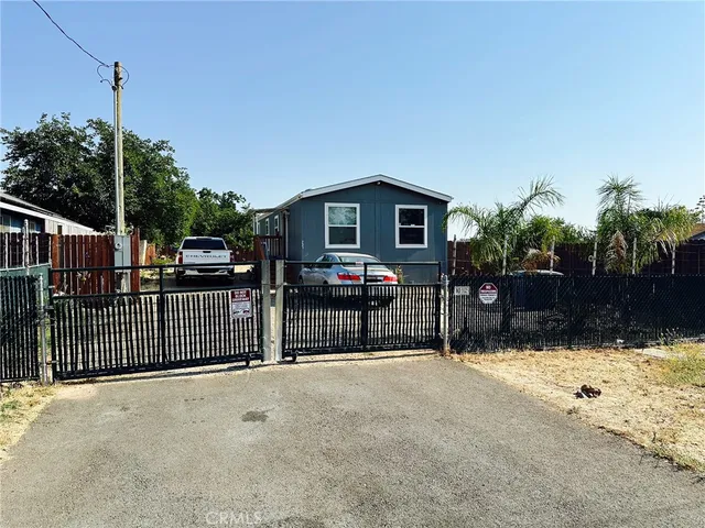 a view of a house with a wooden fence