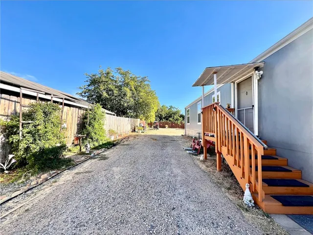 a view of a house with wooden fence