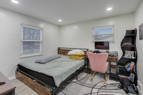 a bedroom with a bed and wooden floor