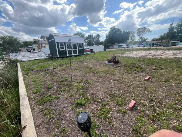 a view of a house with a backyard
