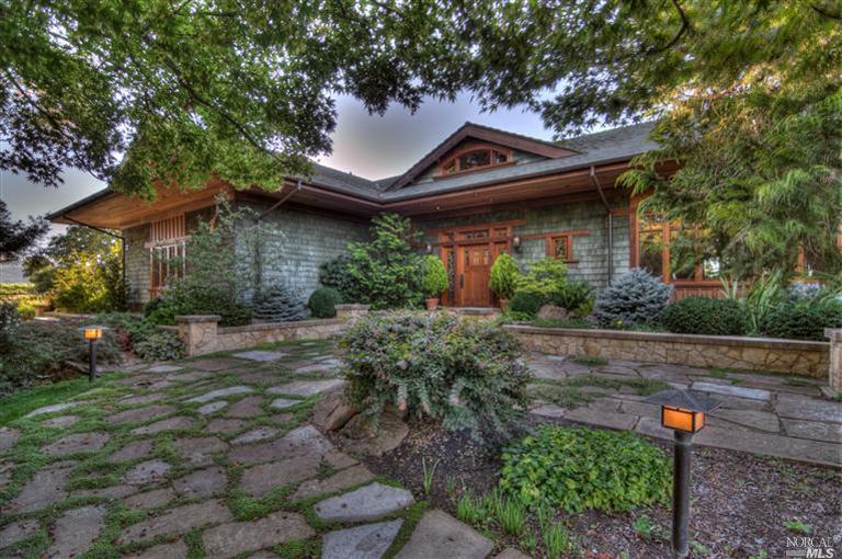 a front view of a house with a garden