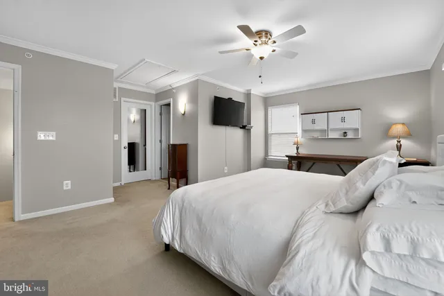 a bedroom with a large bed and a chandelier