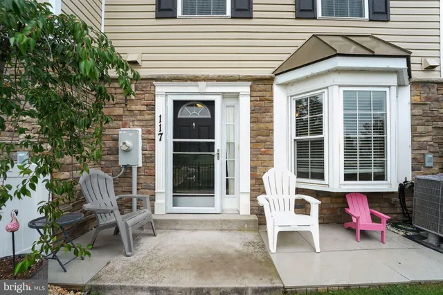 a view of a patio with table and chairs and potted plants