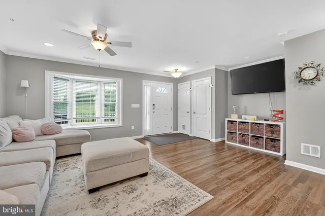 a spacious bedroom with a bed and a flat screen tv