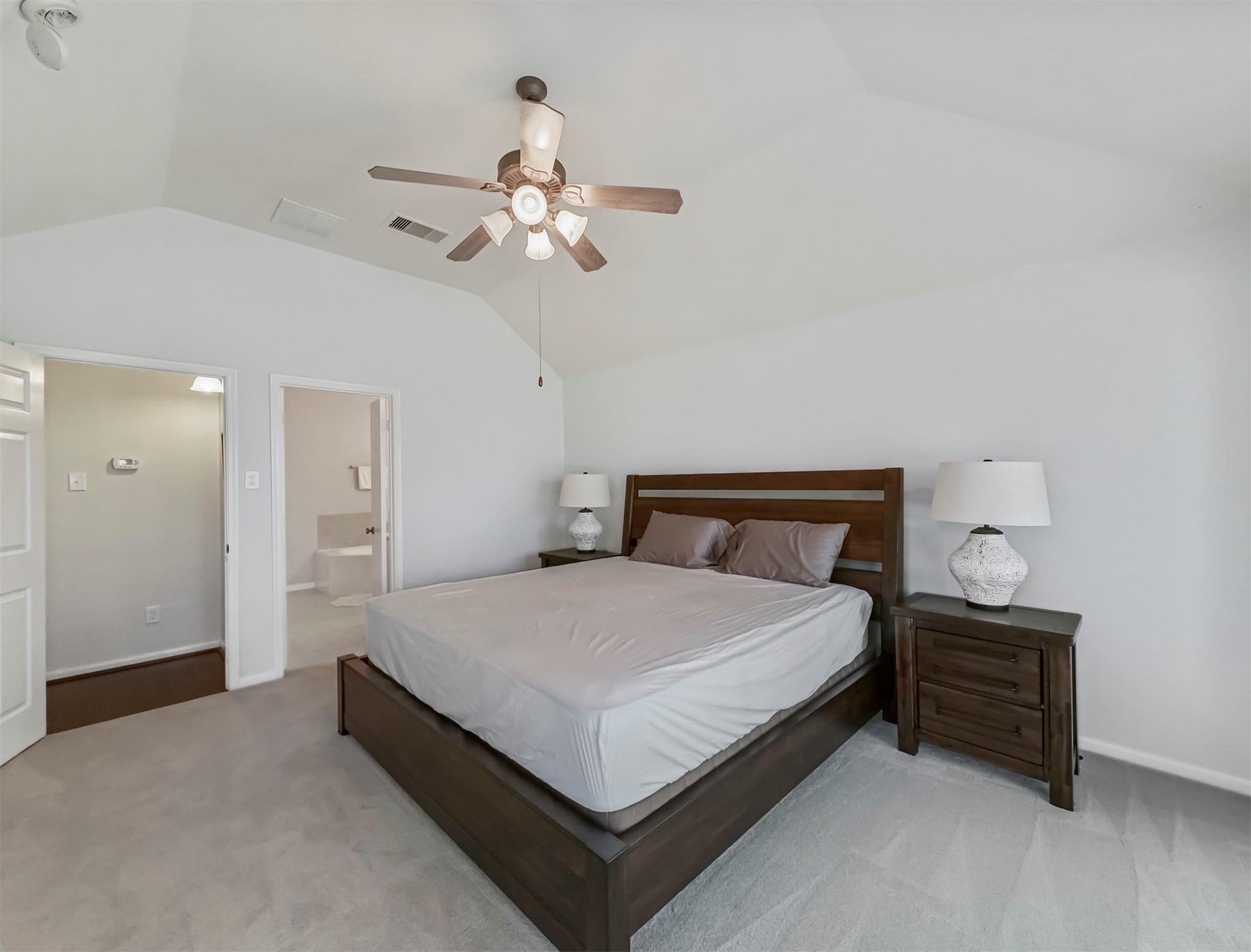 8214 Garrison Point Drive Houston, TX 77040 - Photo 17 of 37 a spacious bedroom with a bed and a chandelier