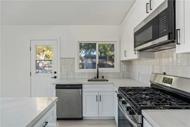 a kitchen that has a sink and a stove
