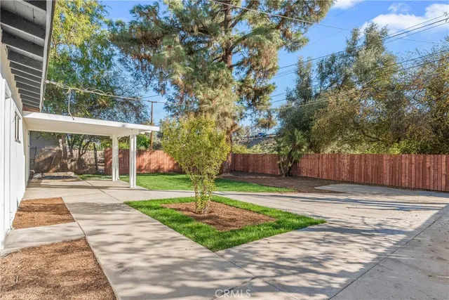 a view of a house with a yard and tree s