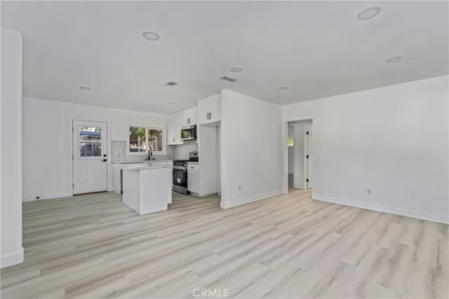 a view of a kitchen with wooden floor