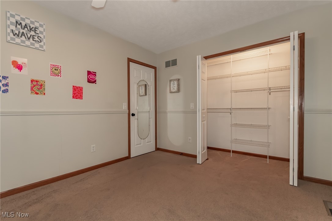 4815 South Ridge Road Perry, OH 44081 - Photo 27 of 48 Unfurnished bedroom featuring a closet and light carpet