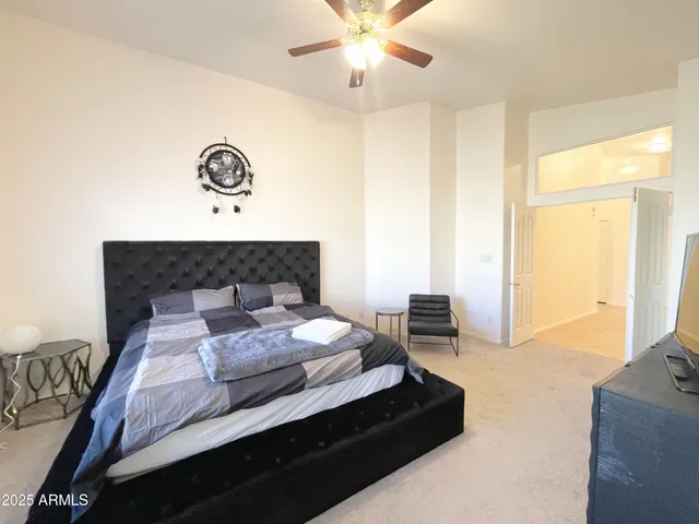 a bedroom with a bed and a chandelier