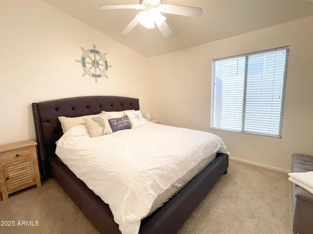 a bedroom with a bed and a painting on the wall