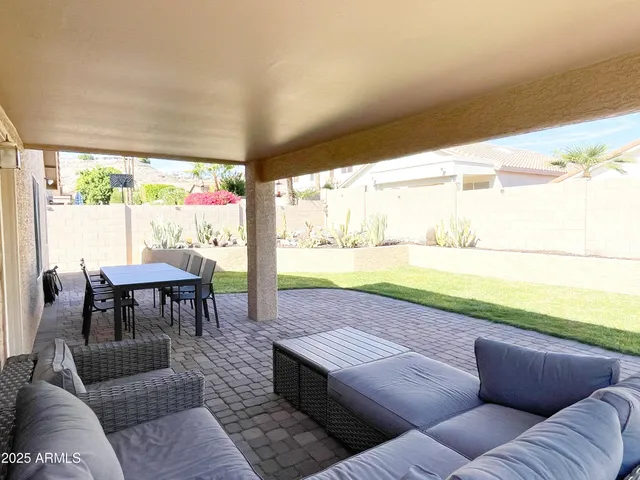 a view of a porch with furniture and a yard