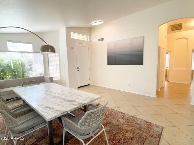 a living room with furniture and flowers