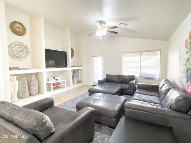 a living room with furniture and a chandelier