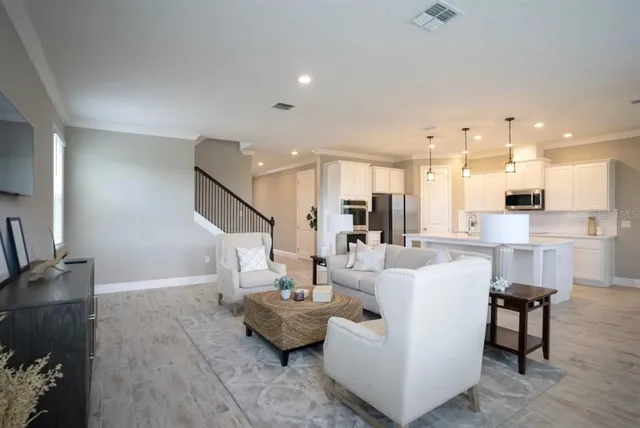 a living room with furniture and kitchen view