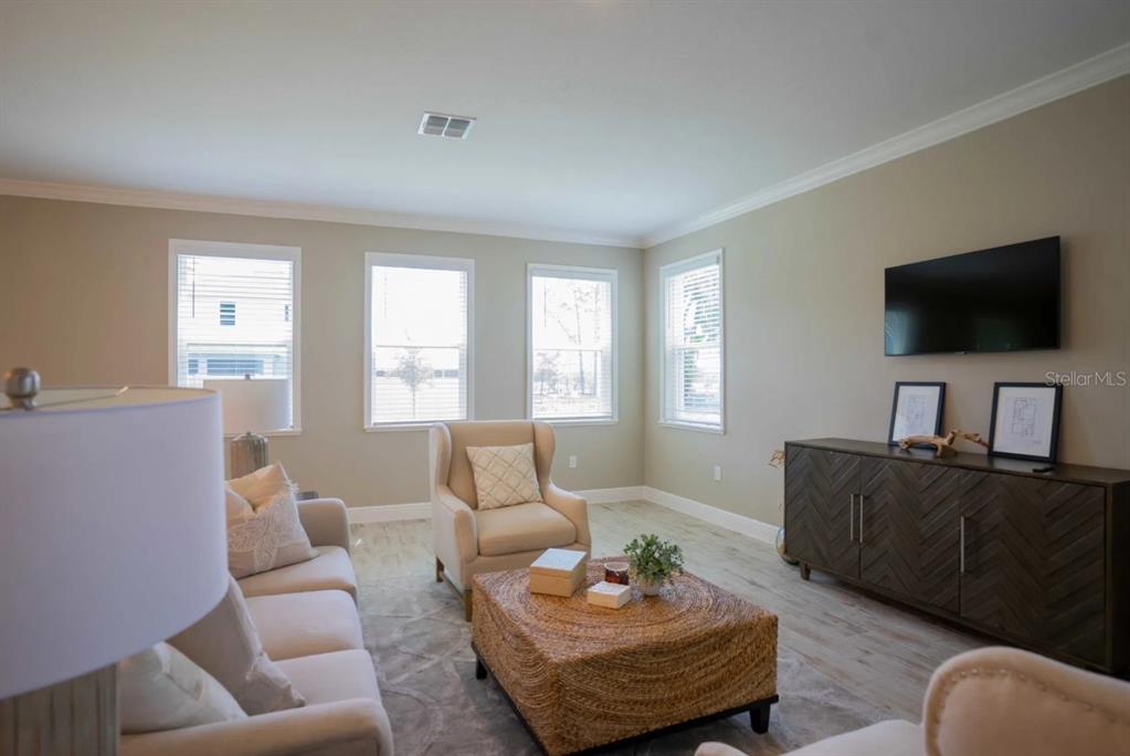 1676 Andover Rdg Drive DeLand, FL 32720 - Photo 7 of 14 a living room with furniture and a flat screen tv