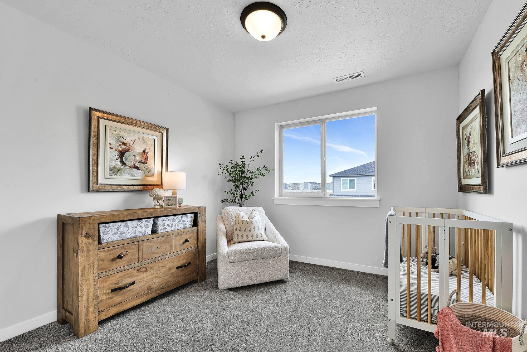 414 South Fritts Avenue Meridian, ID 83642 - Photo 12 of 21 Bedroom with a crib and carpet floors