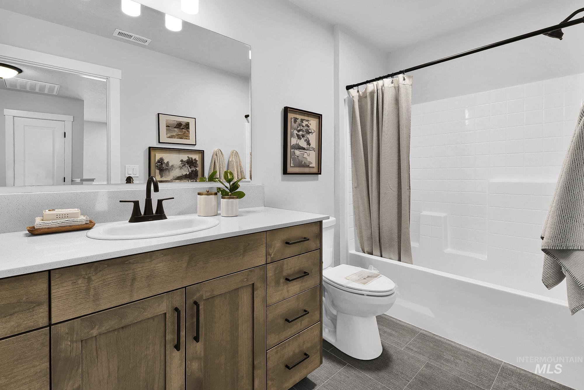 414 South Fritts Avenue Meridian, ID 83642 - Photo 13 of 21 Bathroom featuring vanity and shower / bath combo with shower curtain