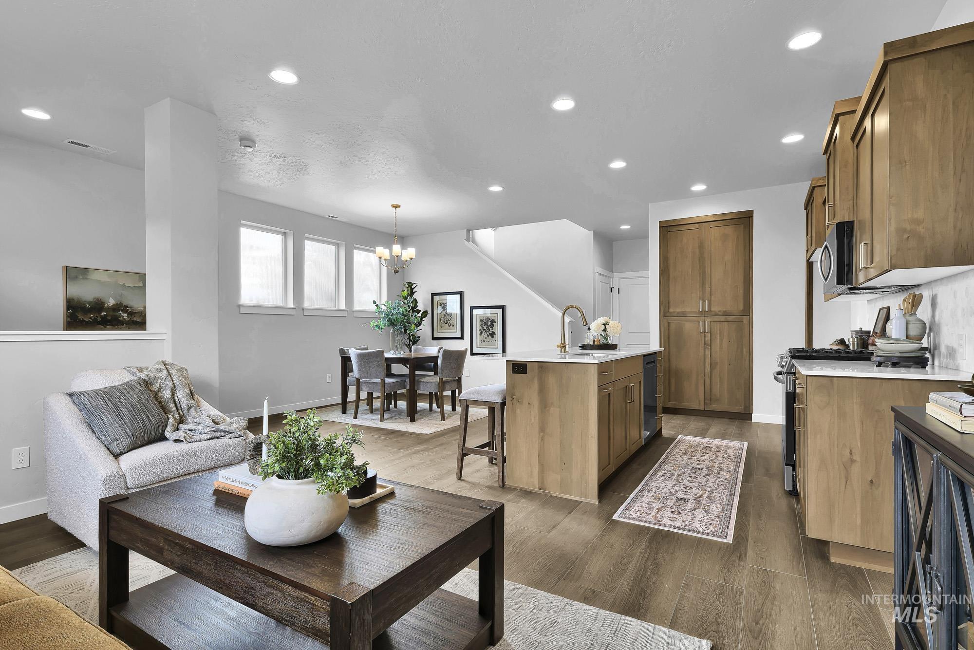 414 South Fritts Avenue Meridian, ID 83642 - Photo 6 of 21 Living room featuring dark wood-type flooring and hanging lights