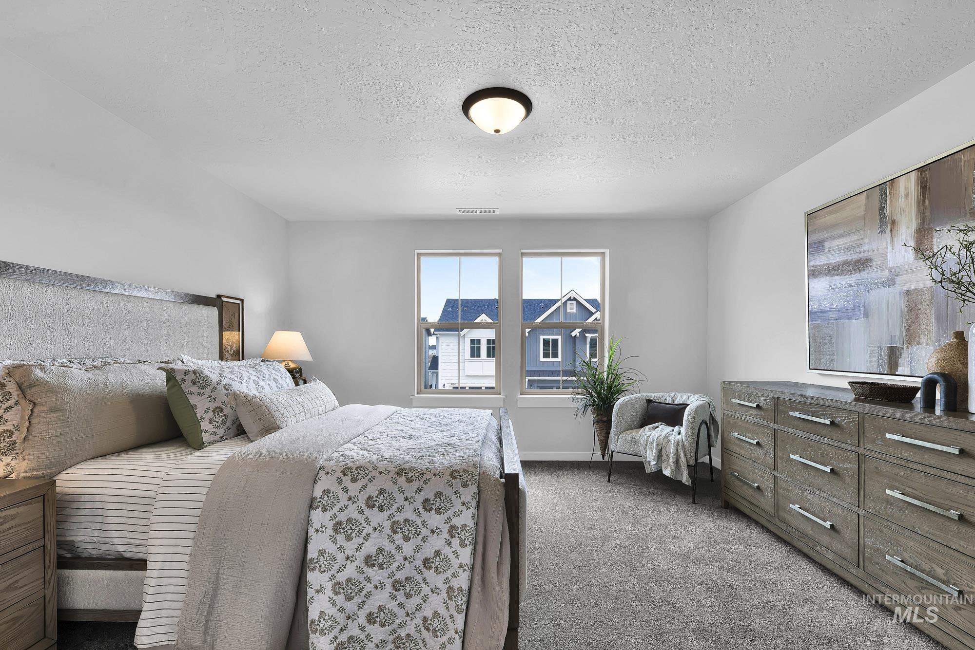414 South Fritts Avenue Meridian, ID 83642 - Photo 7 of 21 Bedroom featuring dark colored carpet and a textured ceiling