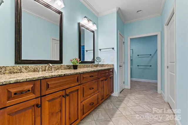 a bathroom with a granite countertop sink double and mirror