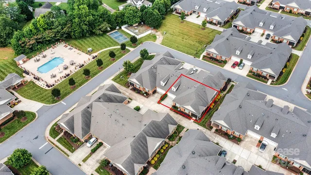 an aerial view of a house with a yard and pool