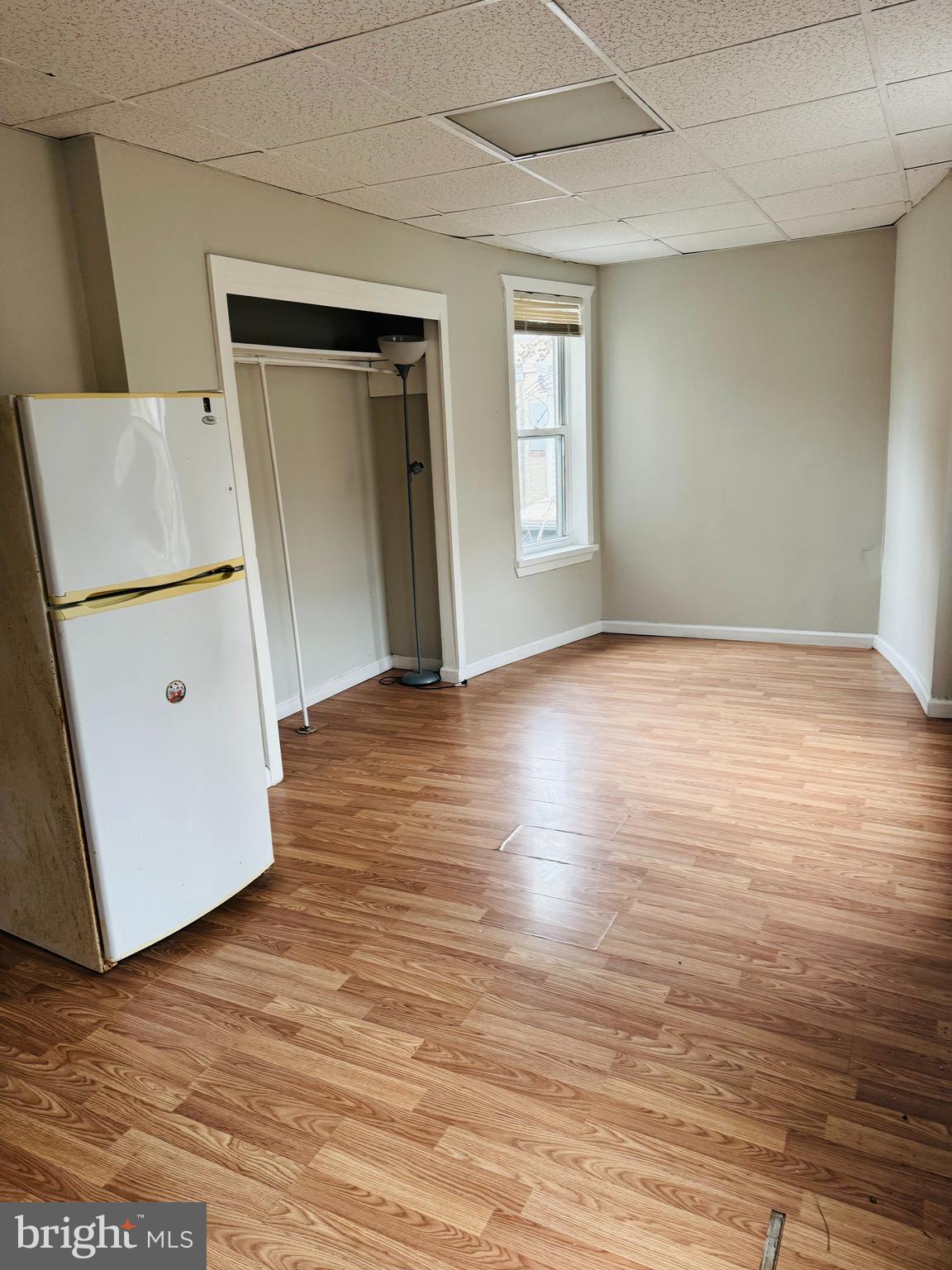 2037 North 8th Street, Unit 2R Philadelphia, PA 19122 - Photo 4 of 5 an empty room with wooden floor and window