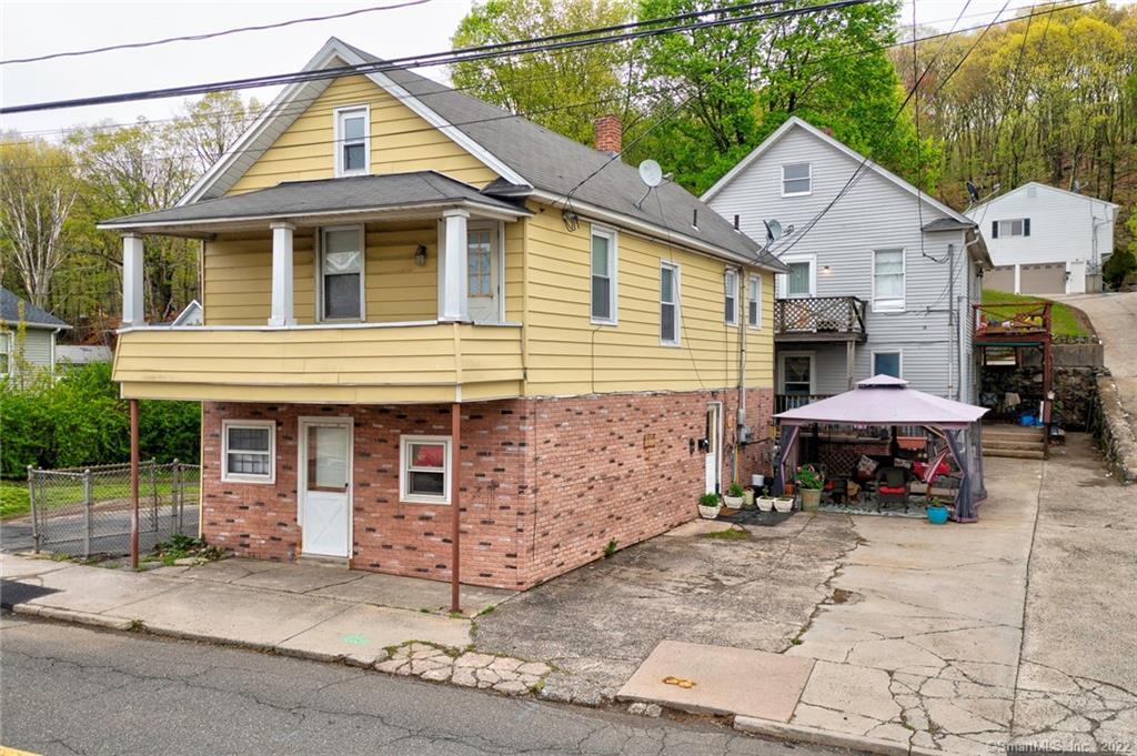 31 High Street Naugatuck, CT 06770 - Photo 1 of 1 a front view of a house with a yard