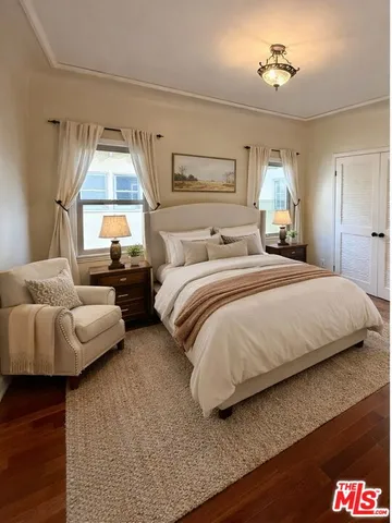 an empty room with wooden floor and cabinet