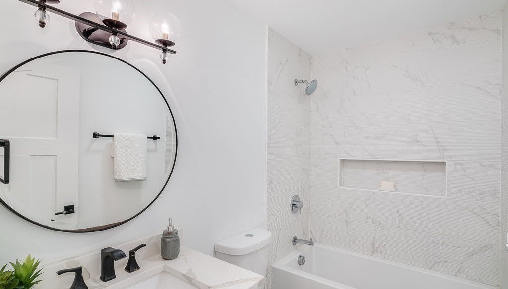 38 Chester Street, Unit 1 Somerville, MA 02144 - Photo 13 of 32 a bathroom with a sink a toilet and a mirror