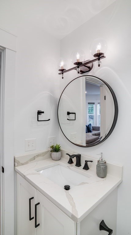 38 Chester Street, Unit 1 Somerville, MA 02144 - Photo 14 of 32 a bathroom with a sink and a mirror